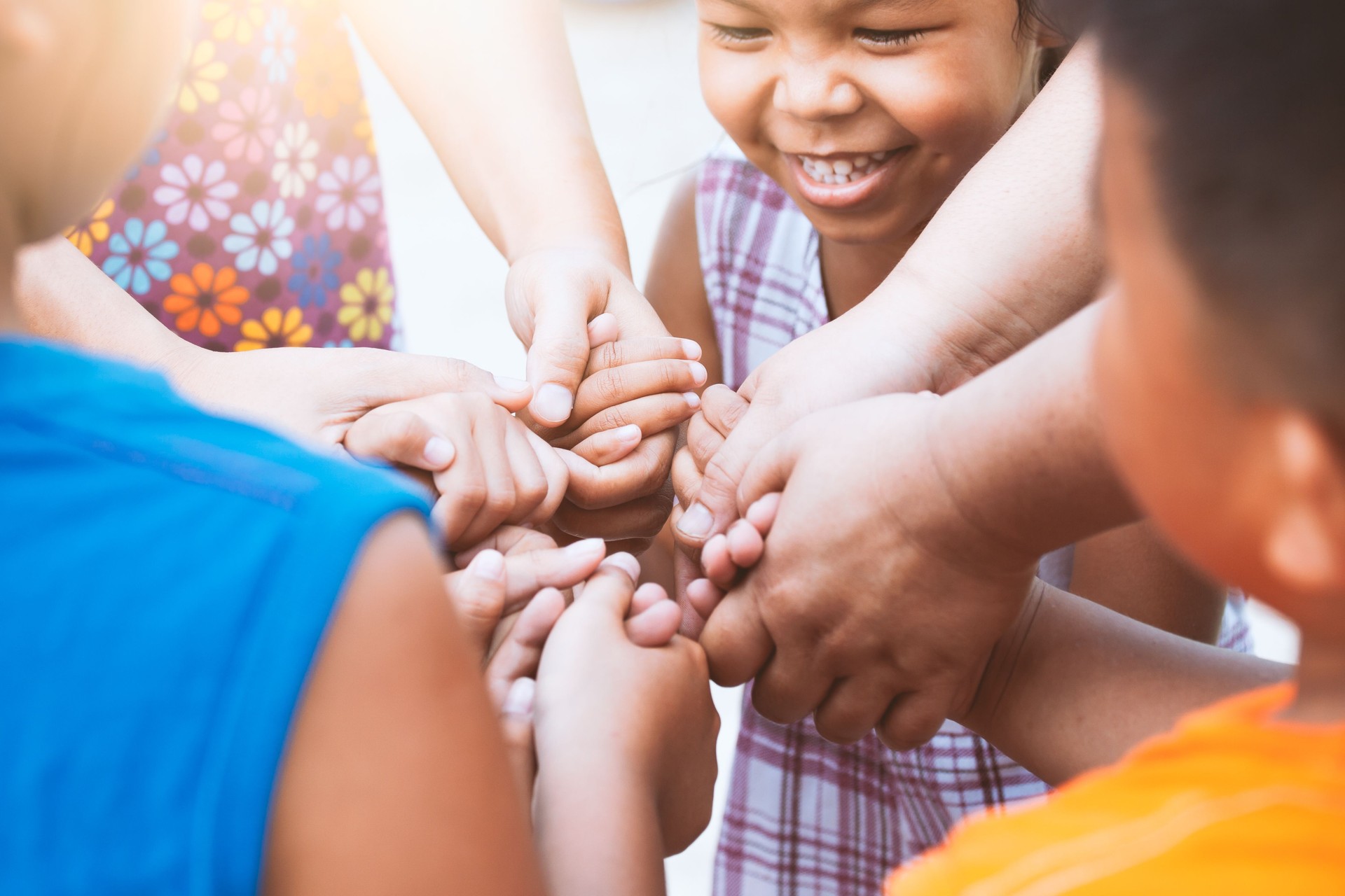 Children and parent holding hands and playing together with unity and teamwork